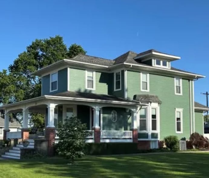 Two-story historic home with sage green exterior siding and white trim painted by Clean Cut Painting & Handyman in Springfield Illinois