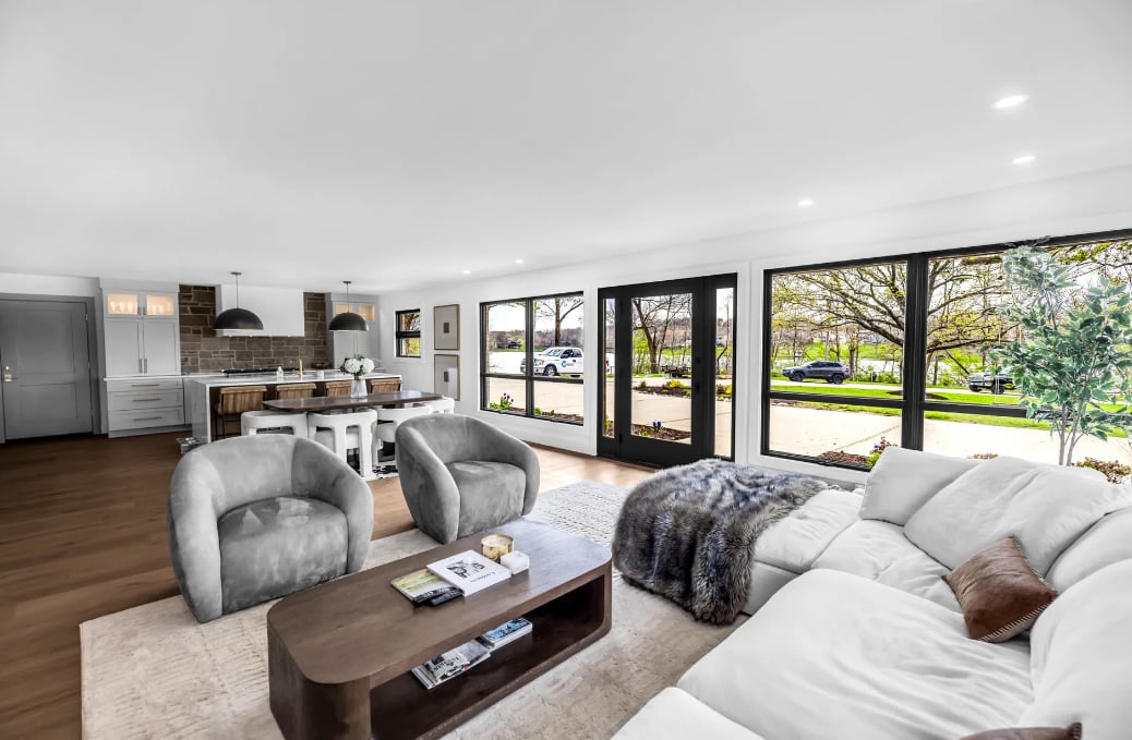 Beautifully painted open concept living room and kitchen with white walls and gray cabinets by Clean Cut Painting in Springfield Illinois