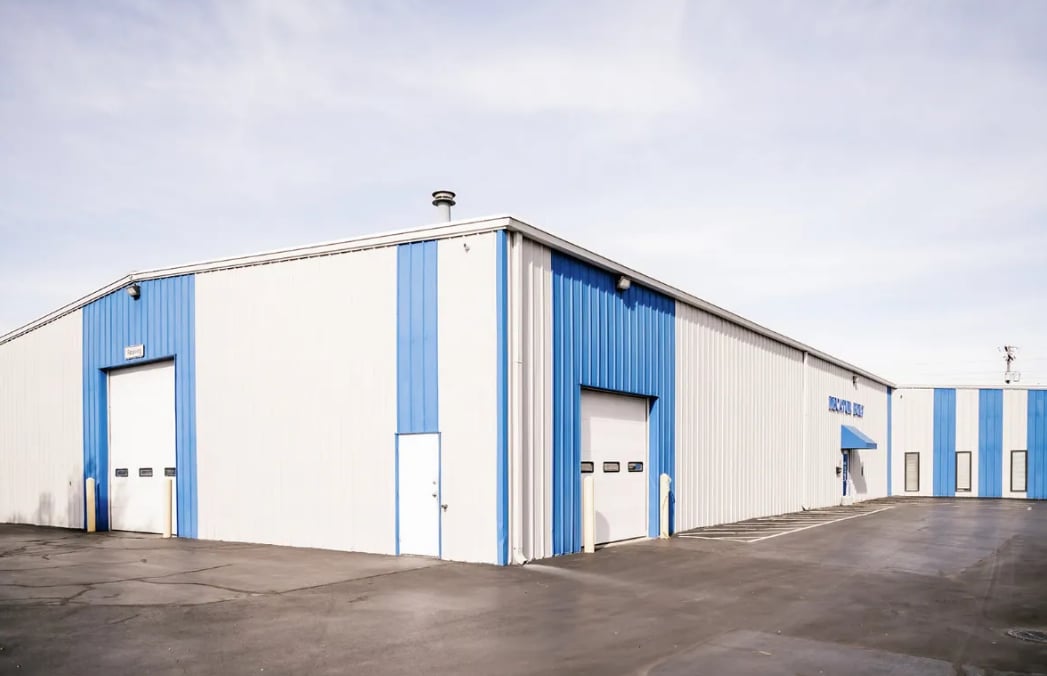 Commercial warehouse building with blue and white exterior paint in Decatur IL - Clean Cut Painting commercial contractor project